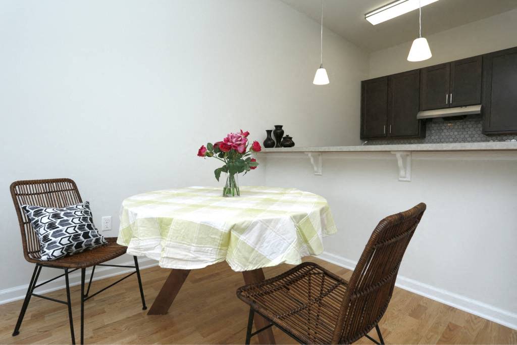 a dining room with a table and two chairs