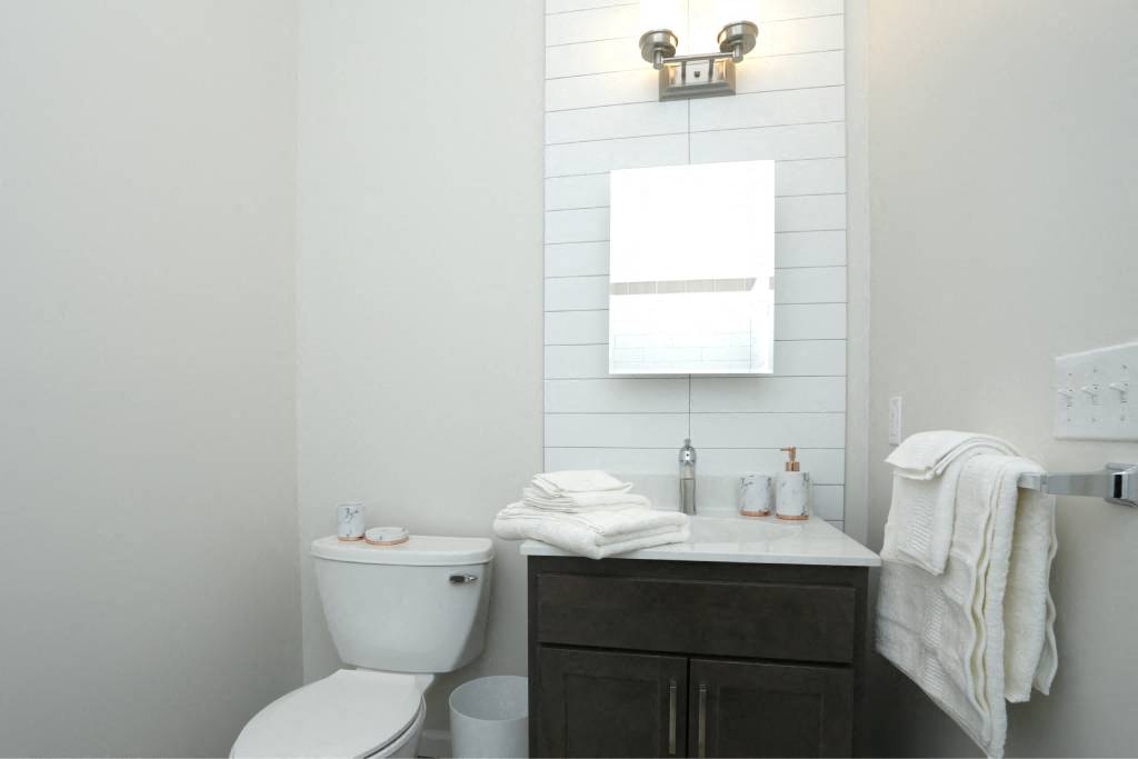 a white bathroom with a toilet and a sink