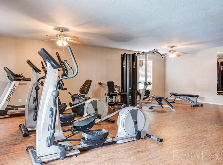 Fitness center with exercise machines at Quail Creek Apartments