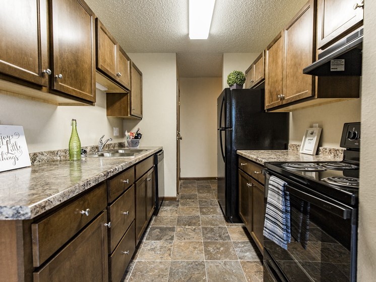 Bismarck, ND Eagle Sky I Apartments. A kitchen with black appliances