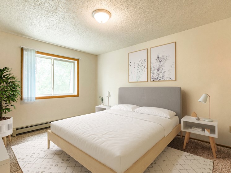 Bismarck, ND Brandon Apartments. A bedroom with a bed and a window