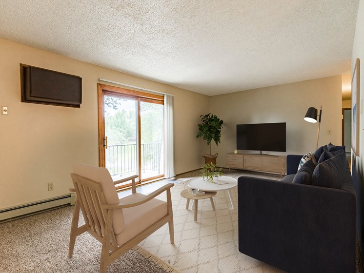 Bismarck, ND Brandon Apartments. A living room with a couch and a chair