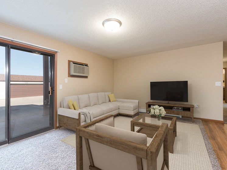Bismarck, ND Fairview. a living room with a tv and a sliding glass door