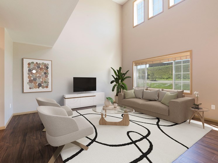 Bismarck, ND Stonefield Townhomes. The large room showcases comfortable seating, modern decor, and natural lighting, creating a welcoming and relaxing space for residents.