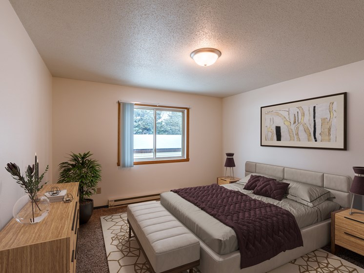 a bedroom with a bed and a window. Fargo, ND Long Island Apartments