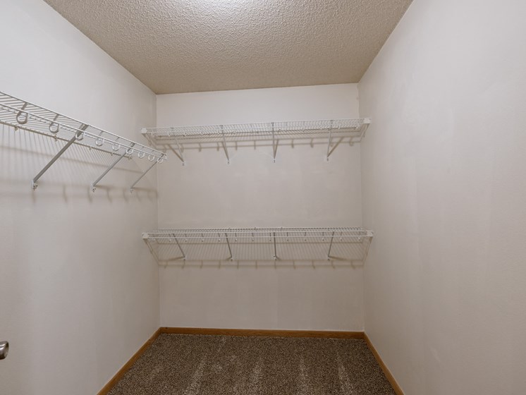 a closet with three shelves. Moorhead, MN Mallard Creek Apartments