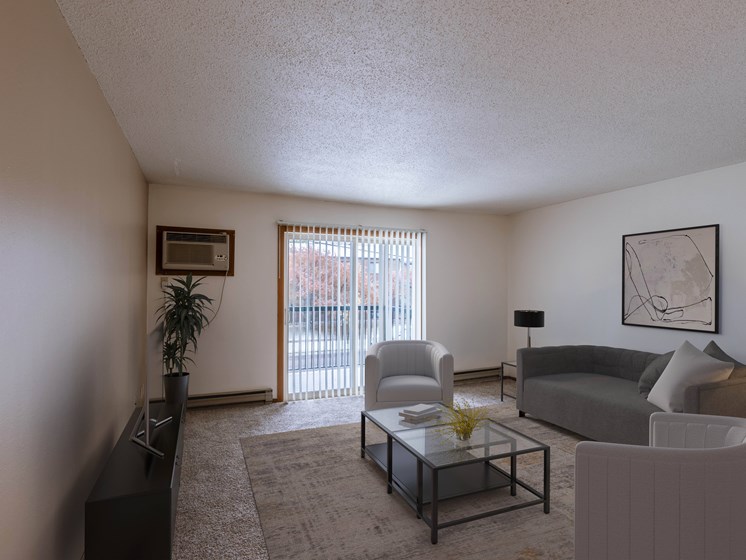 an apartment living room with a couch and a coffee table. Fargo, ND West Oak Apartments