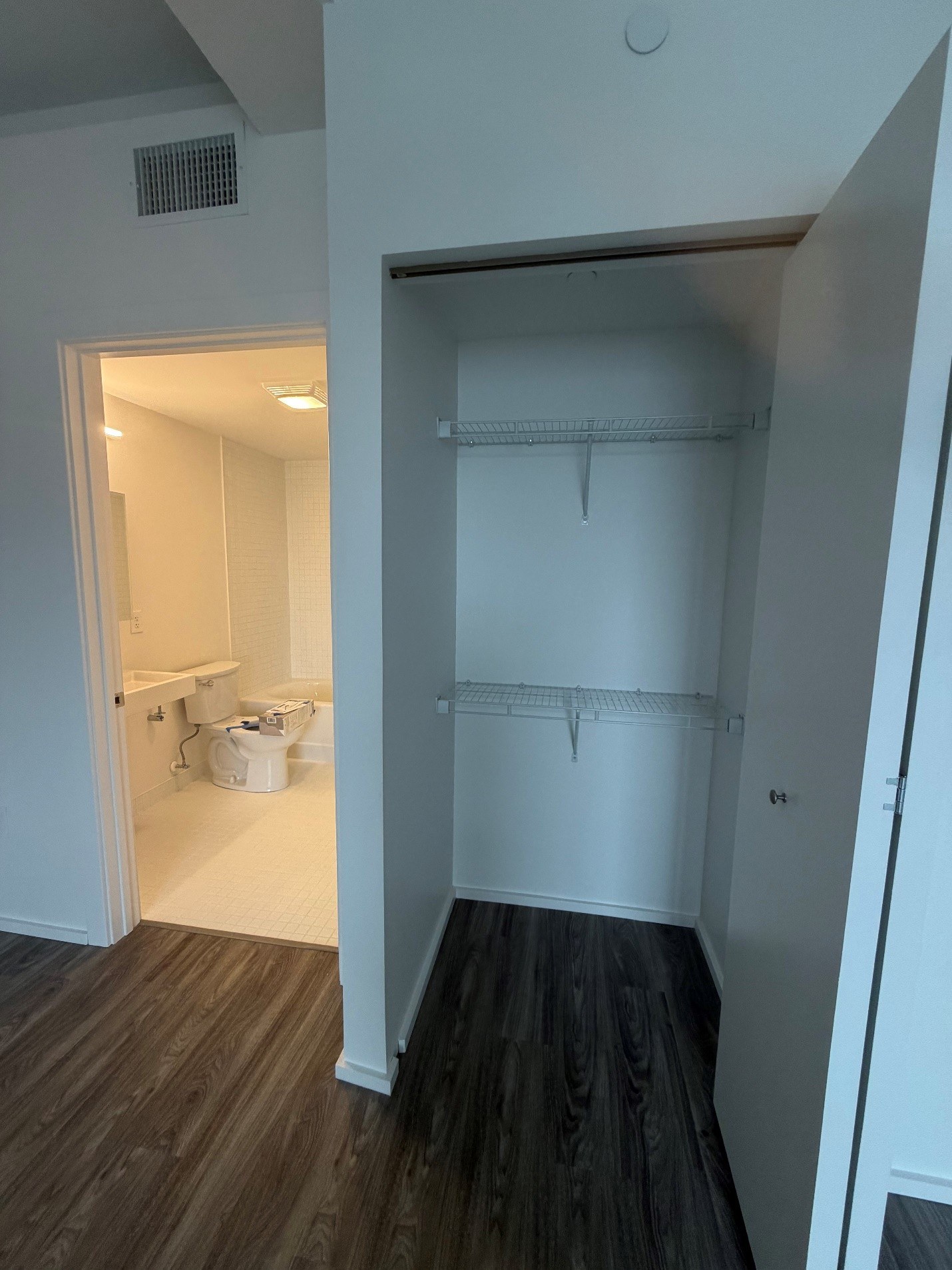 A white room with a doorway leading to another room.