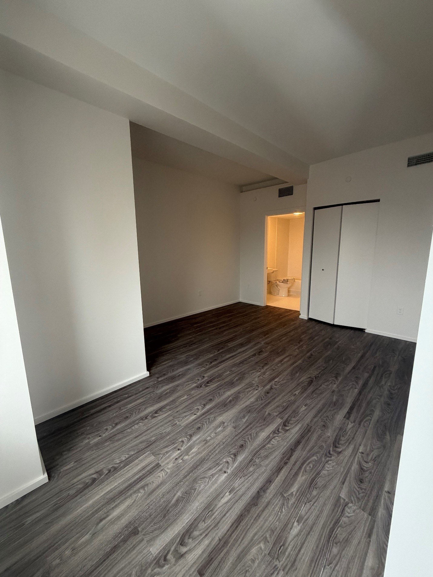 A room with a grey floor and white walls.