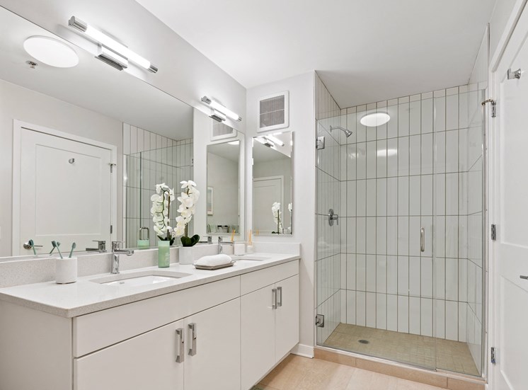 Apartment bathroom with double sink vanity at 23rd Place at Southbridge in Chicago, IL