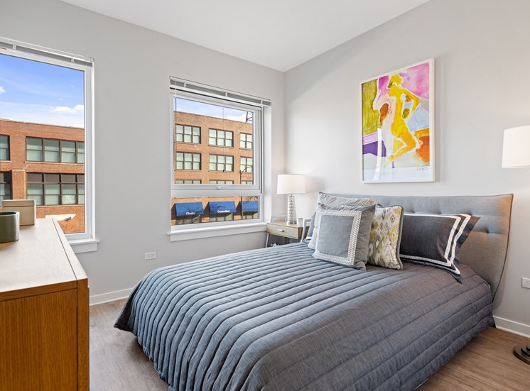 Spacious bedroom with hardwood-style flooring at 23rd Place at Southbridge in Chicago, IL for rent