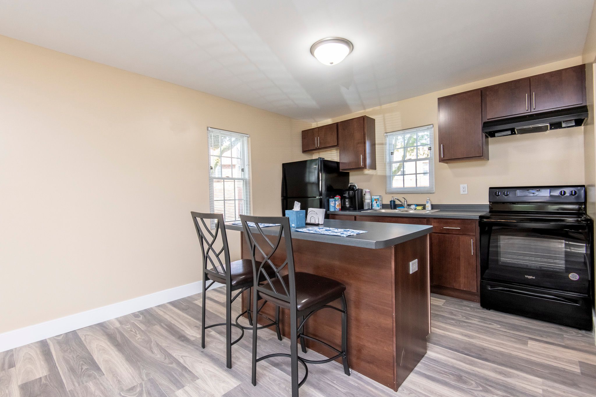 A kitchen with a black oven and a black microwave.