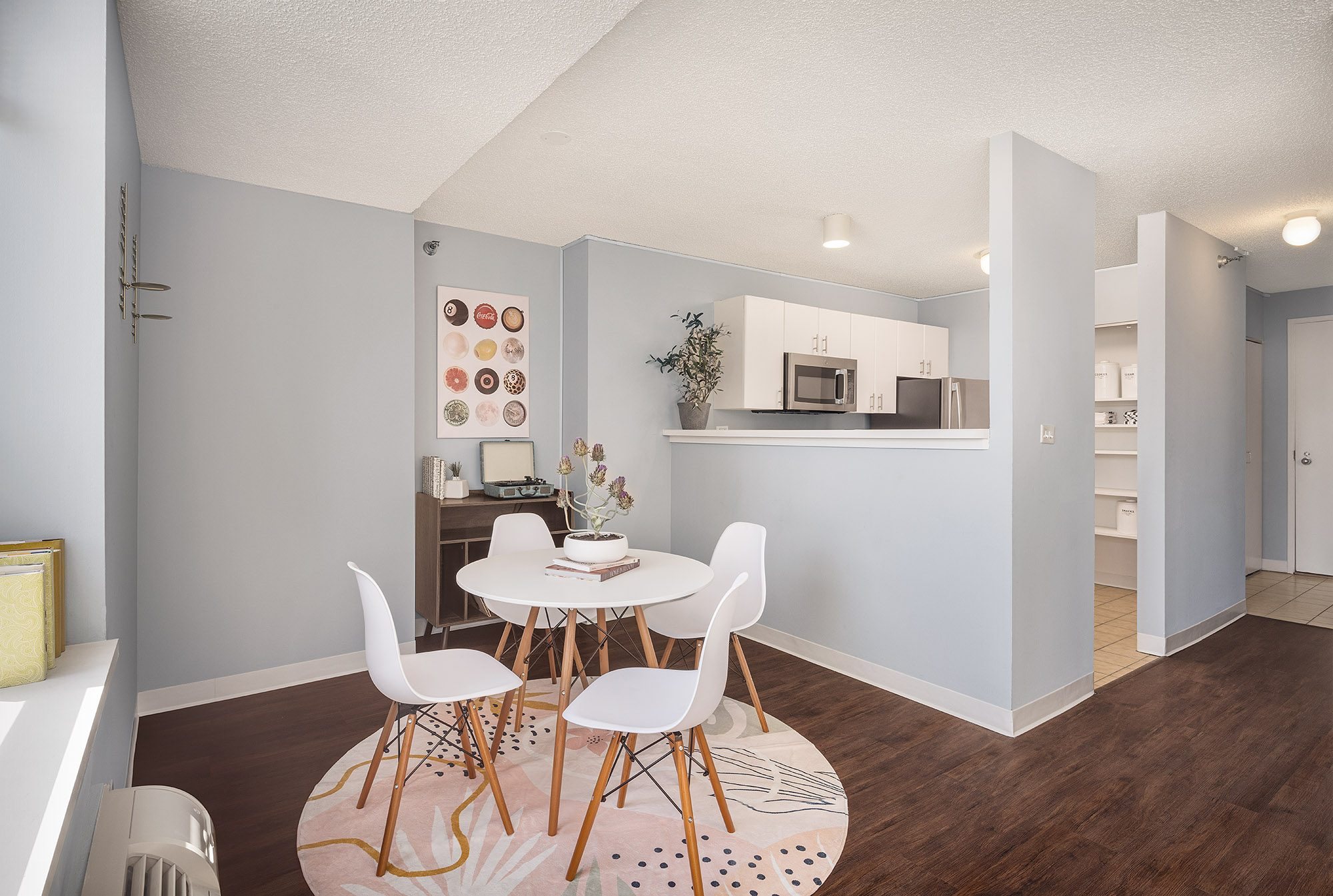 A kitchen with a table and chairs in the middle of the room.