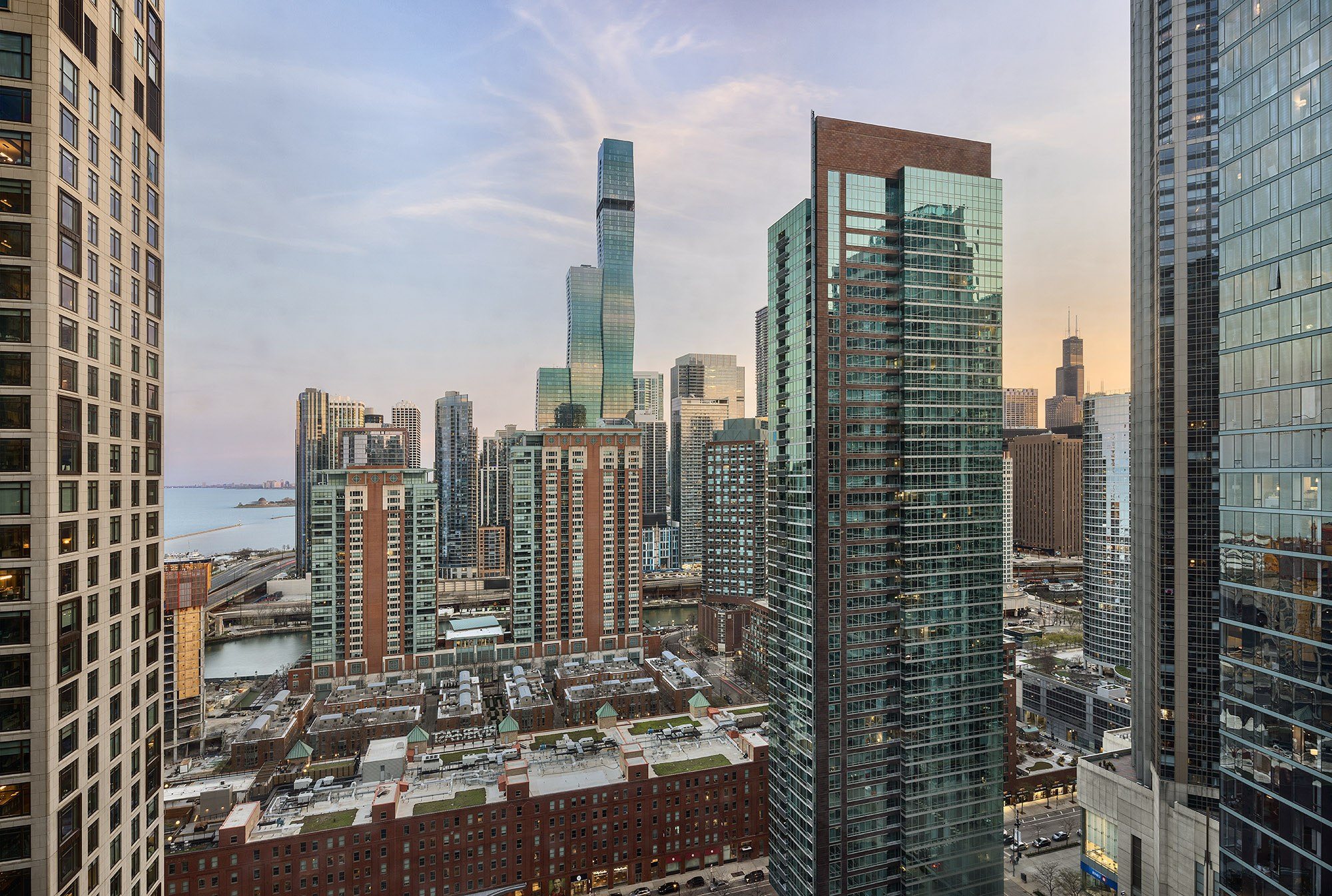 A cityscape with a mix of modern and older buildings, with a clear sky above.