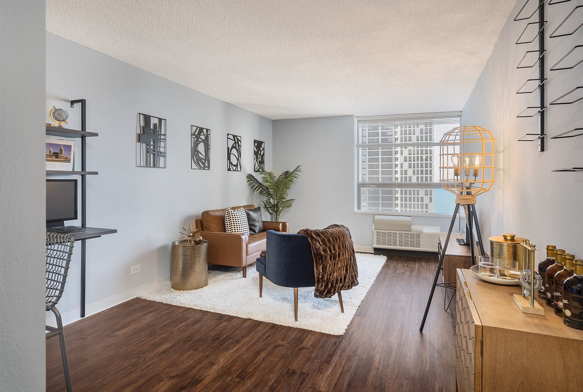 A living room with a brown sofa and a black chair.
