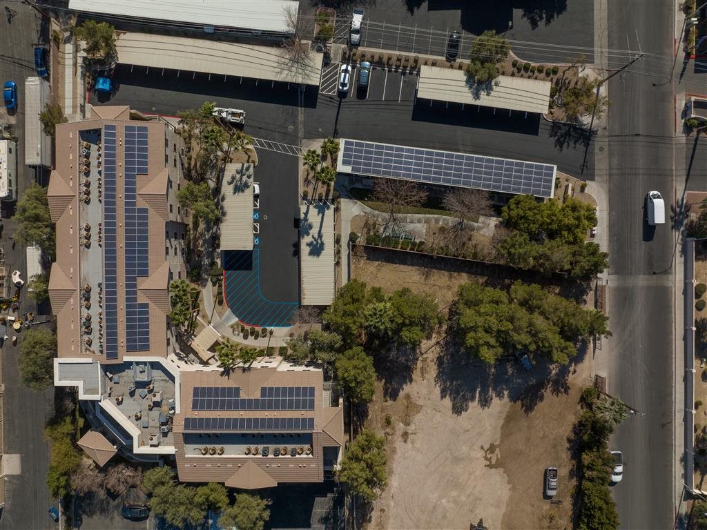 An aerial view of a building with solar panels on the roof.