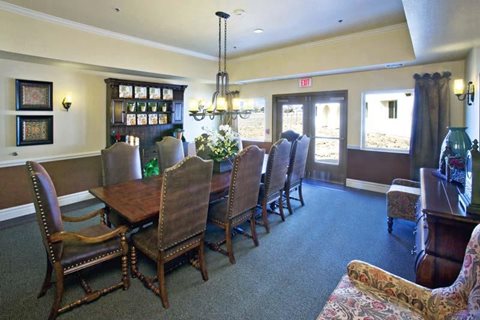 A room with a long table and chairs.