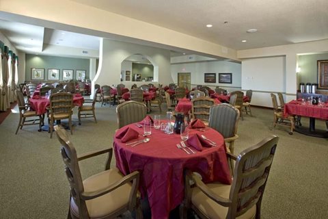 A dining room with tables set for a meal.