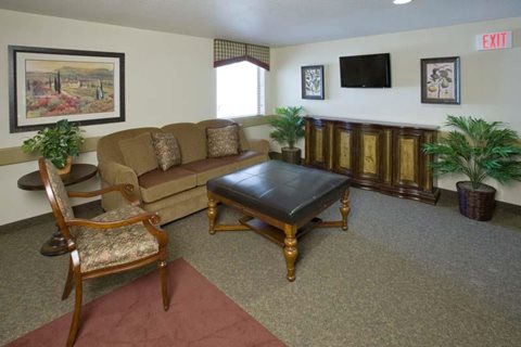 A living room with a brown couch, a chair, and a coffee table.