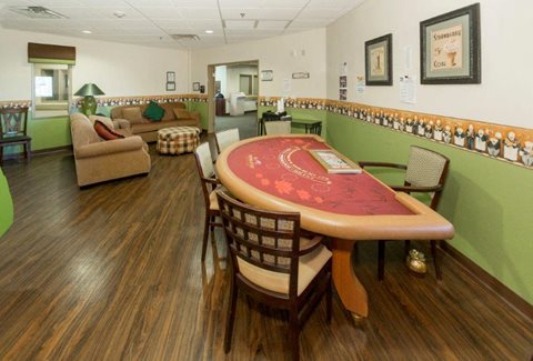 A room with a poker table and chairs.