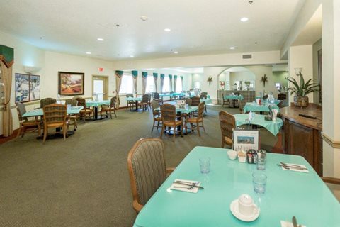 A dining room with tables set for a meal.