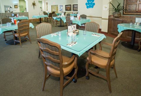 A restaurant with tables and chairs set up for dining.