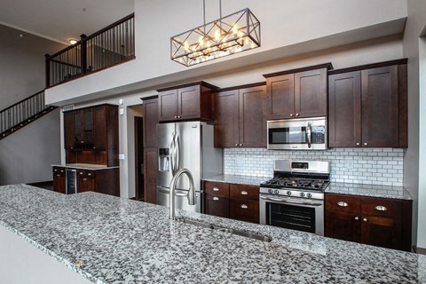 Designer Kitchen Equipped with Stainless Steal Appliances & Designer Cabinetry