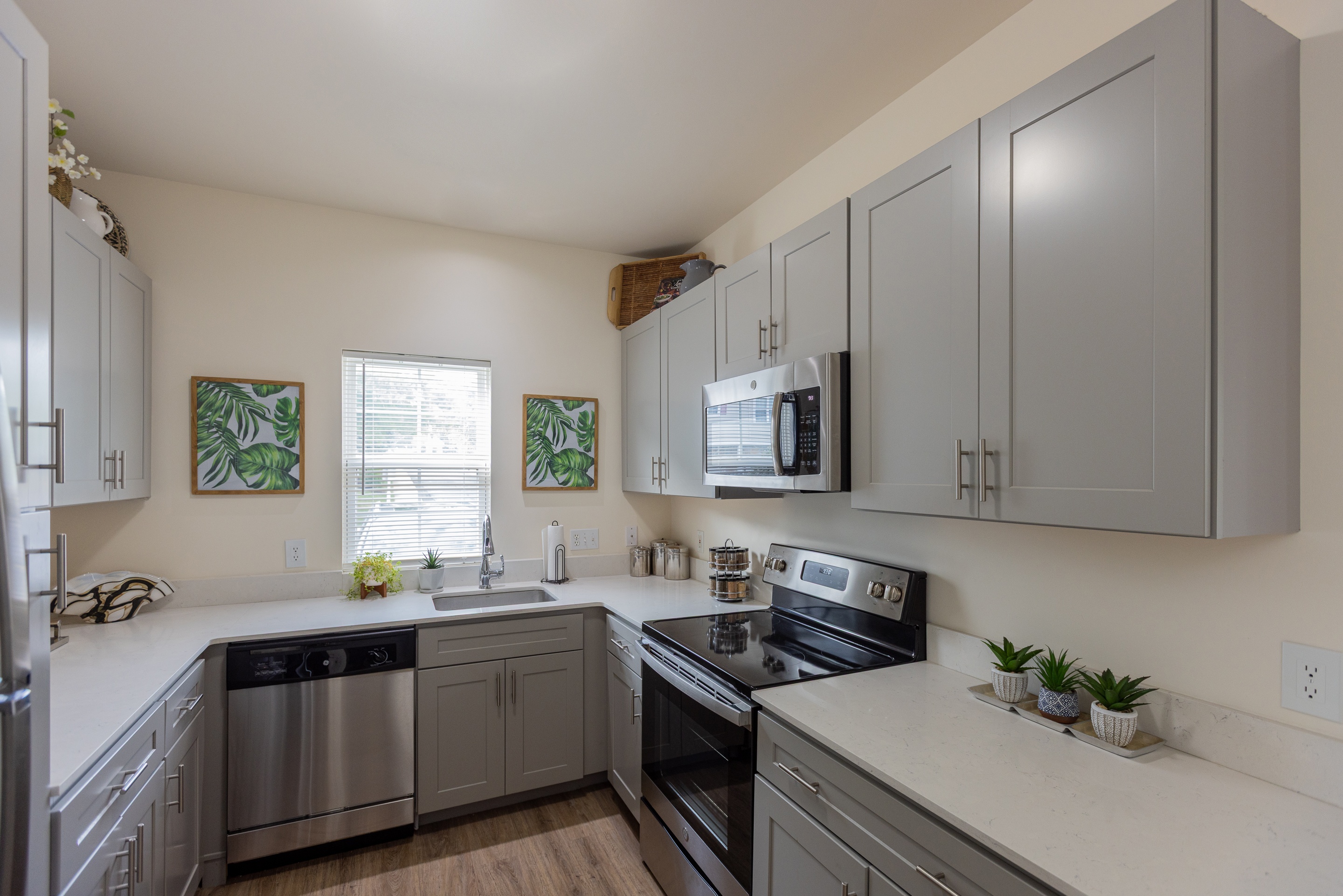 A kitchen with a stove, oven, and refrigerator.