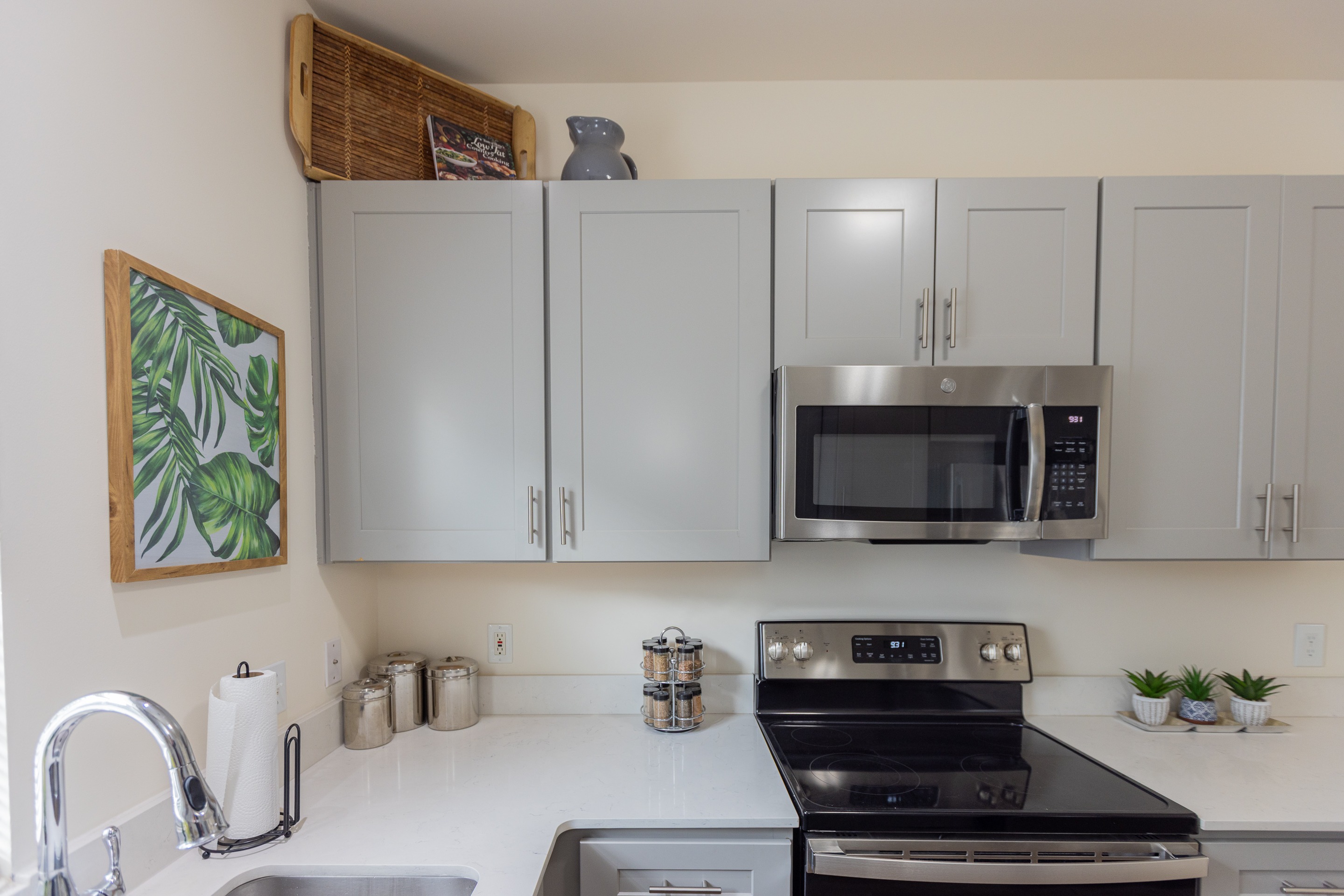 A kitchen with a stove top oven and a microwave above it.