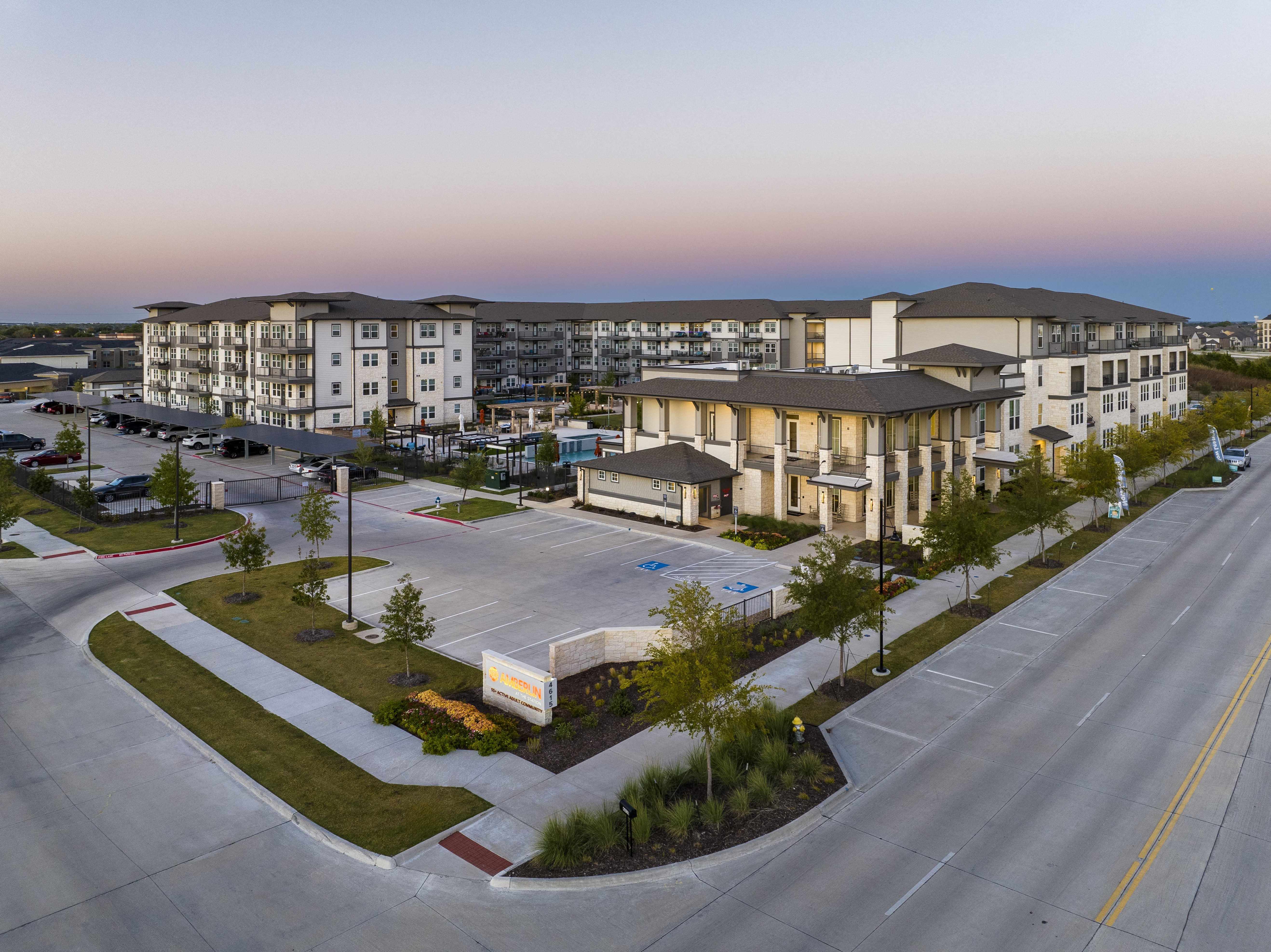 an aerial view of a senior apartment community and parking lot
