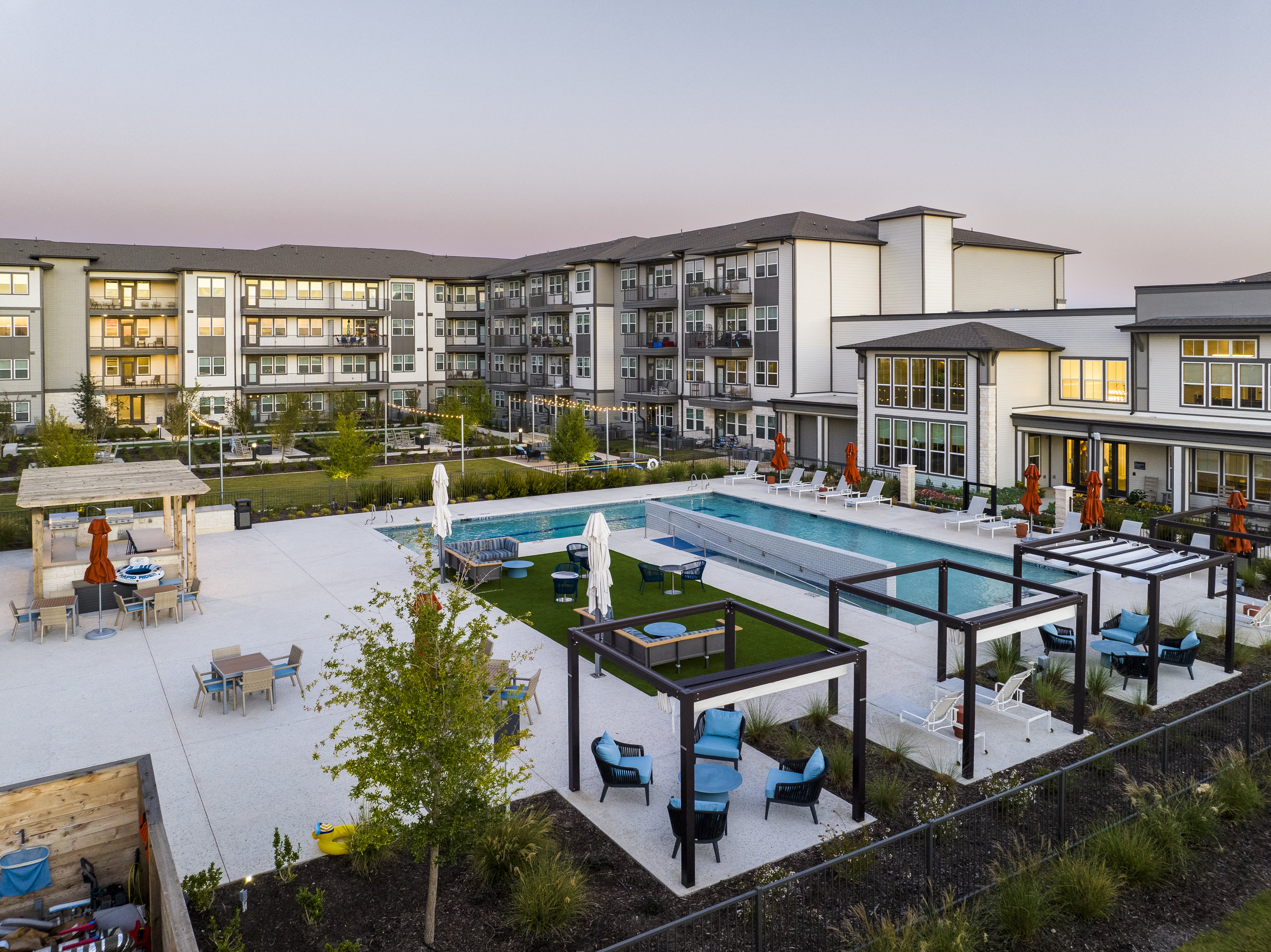a rendering of an apartment complex with a resort style pool and courtyard at a senior apartment community