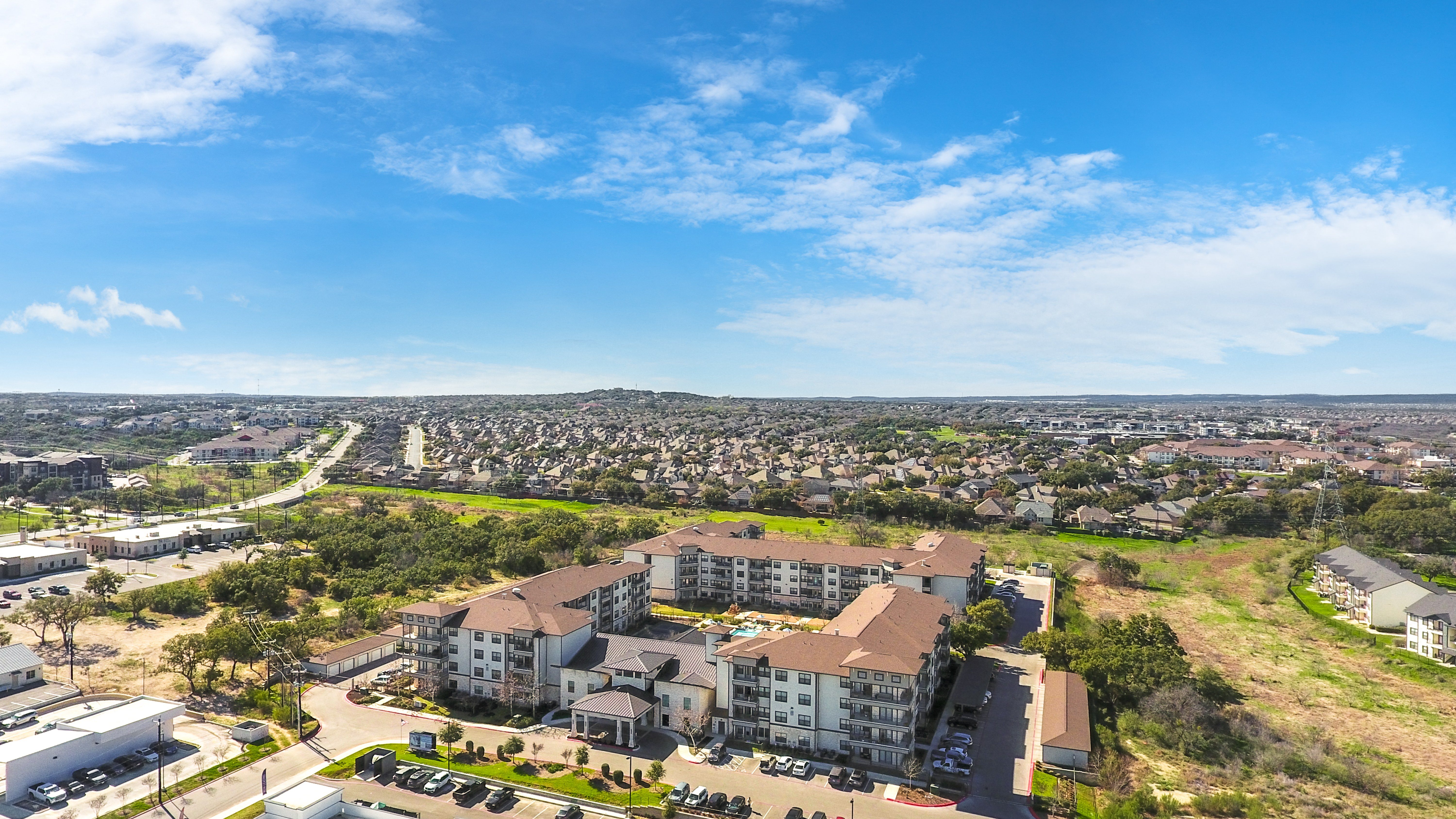 an aerial view of a senior apartment community and surrounding land
