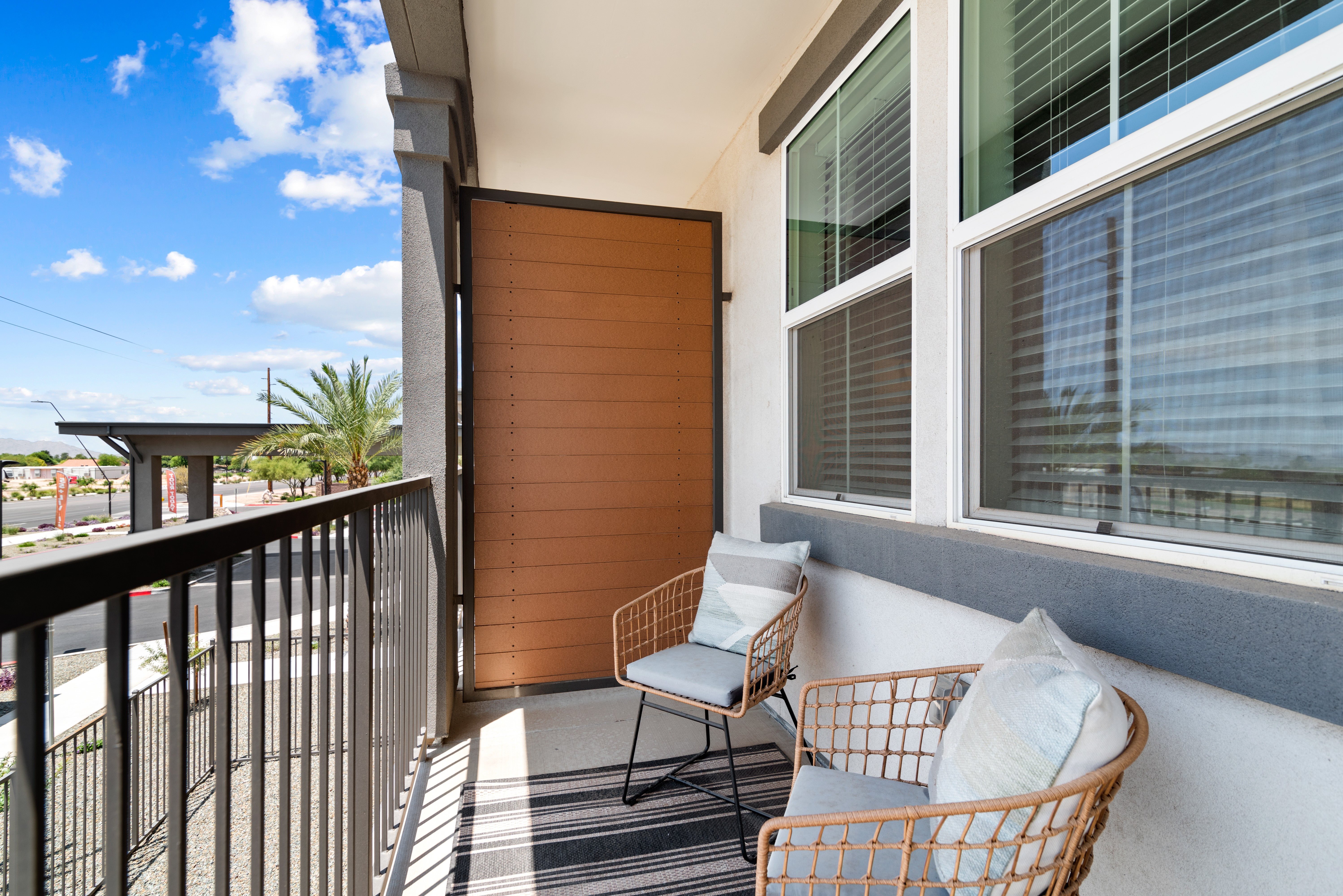 A balcony with a chair and a table.