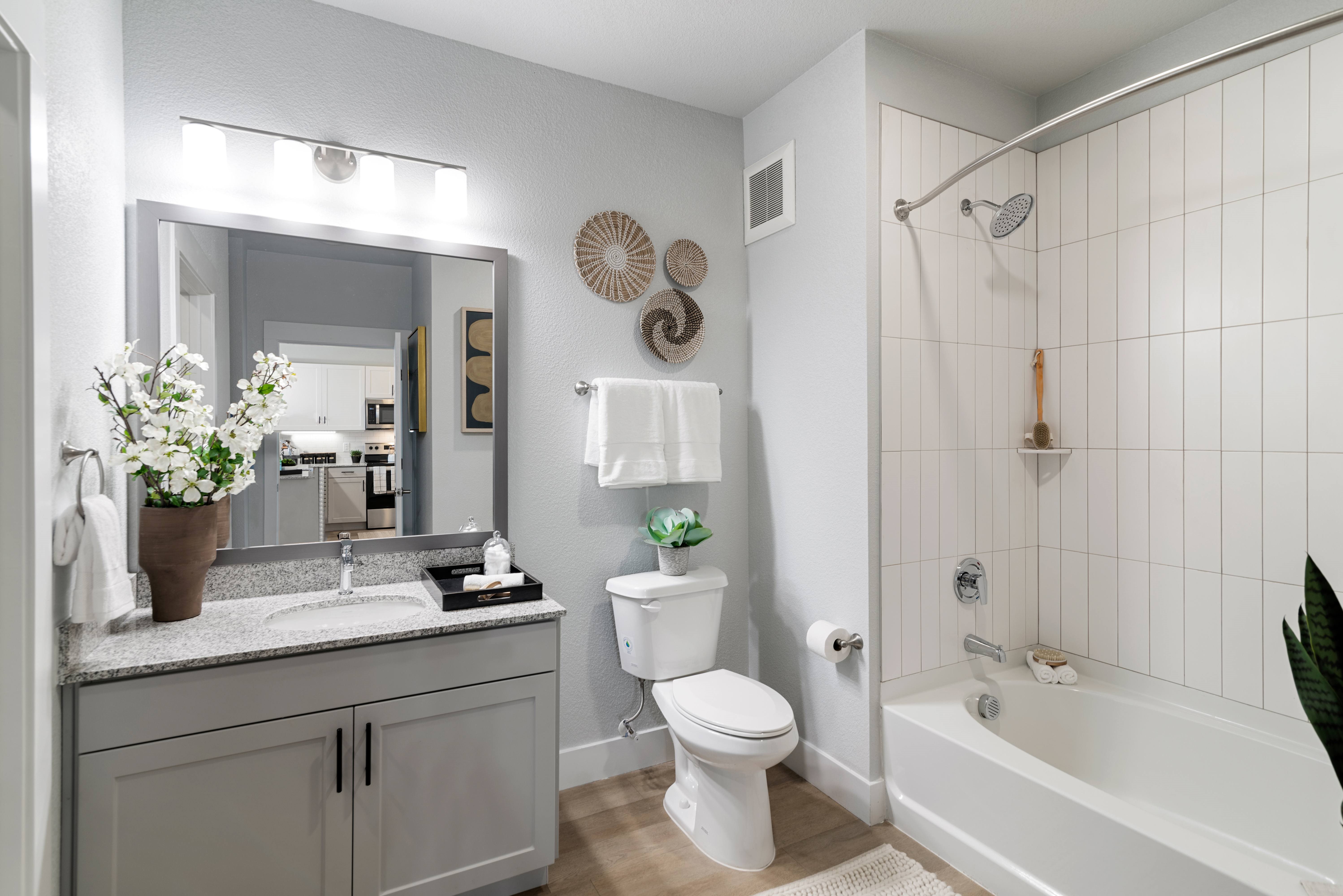 A white bathroom with a sink, toilet, and bathtub.