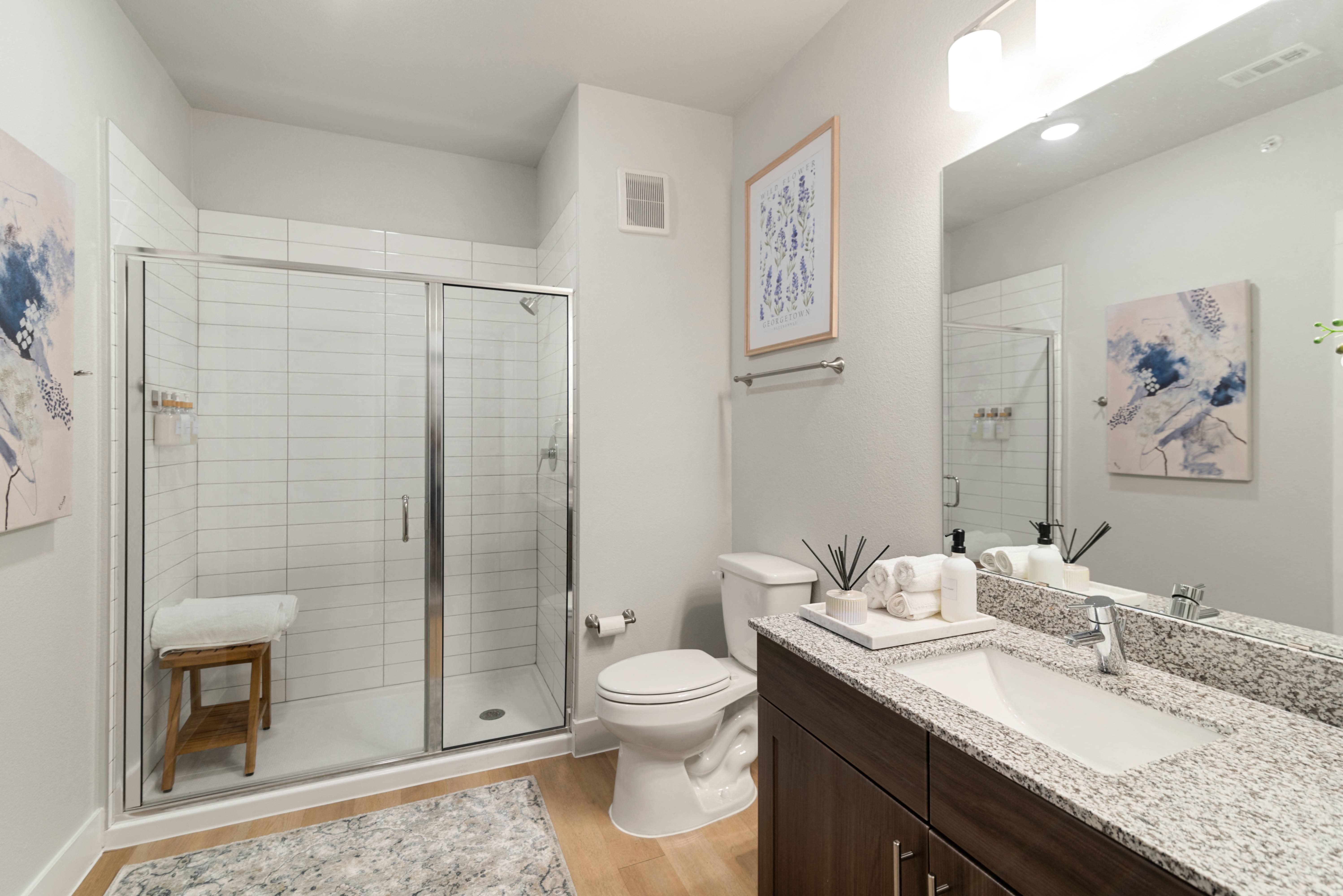 a bathroom with a shower toilet and sink