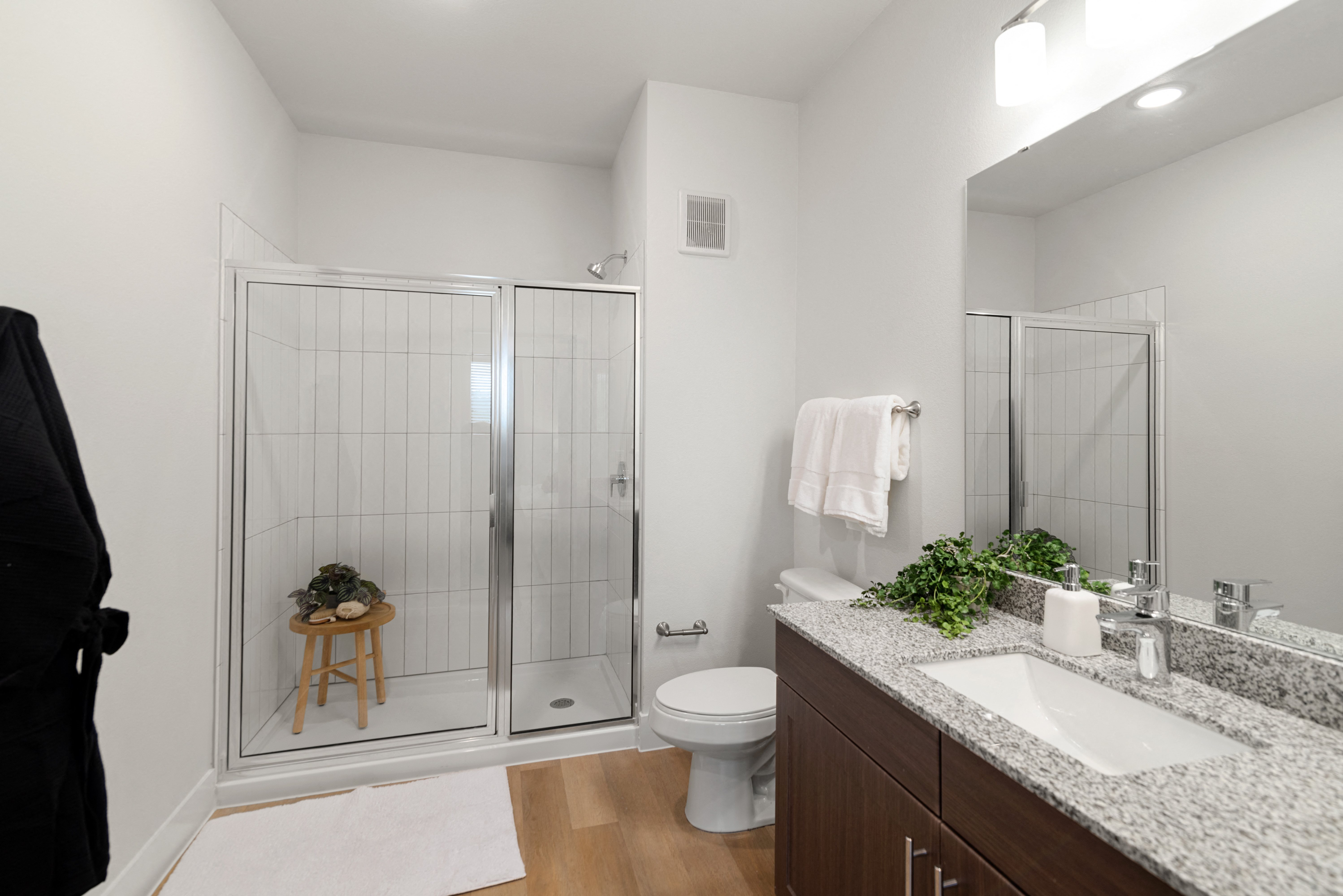 a bathroom with a shower and a sink and a toilet