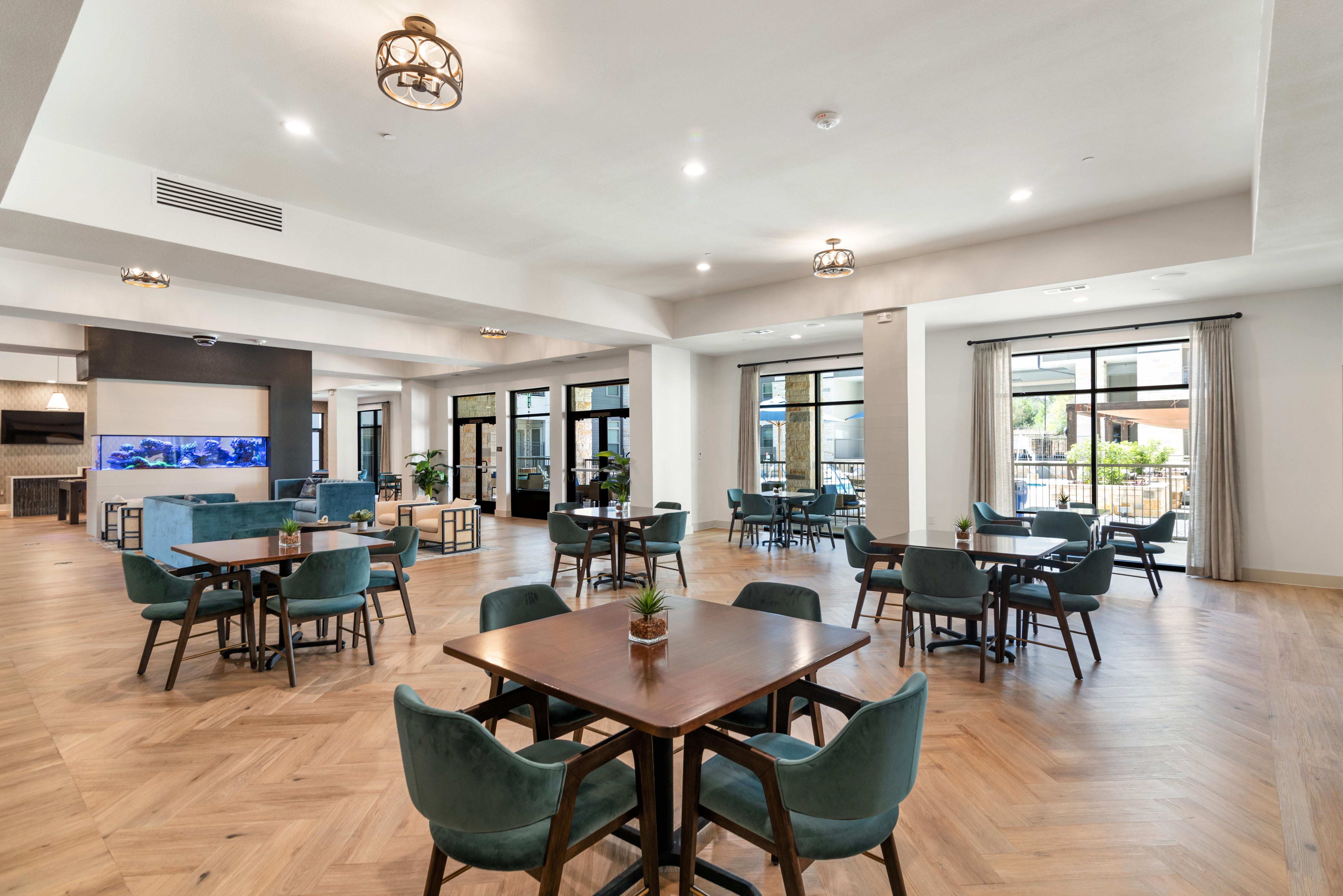 A large room with a long table and chairs.