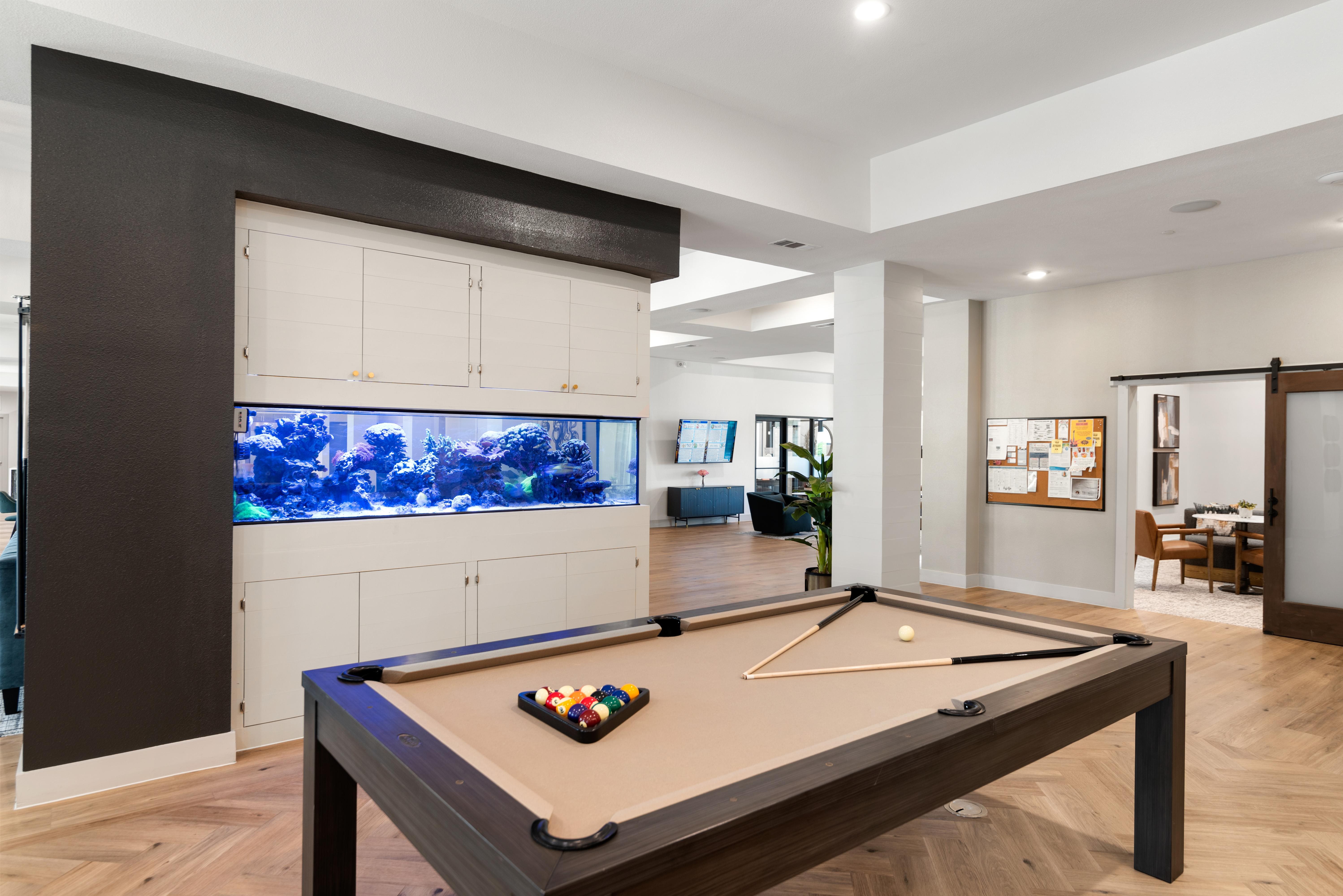 A pool table with a ball on it in a room.