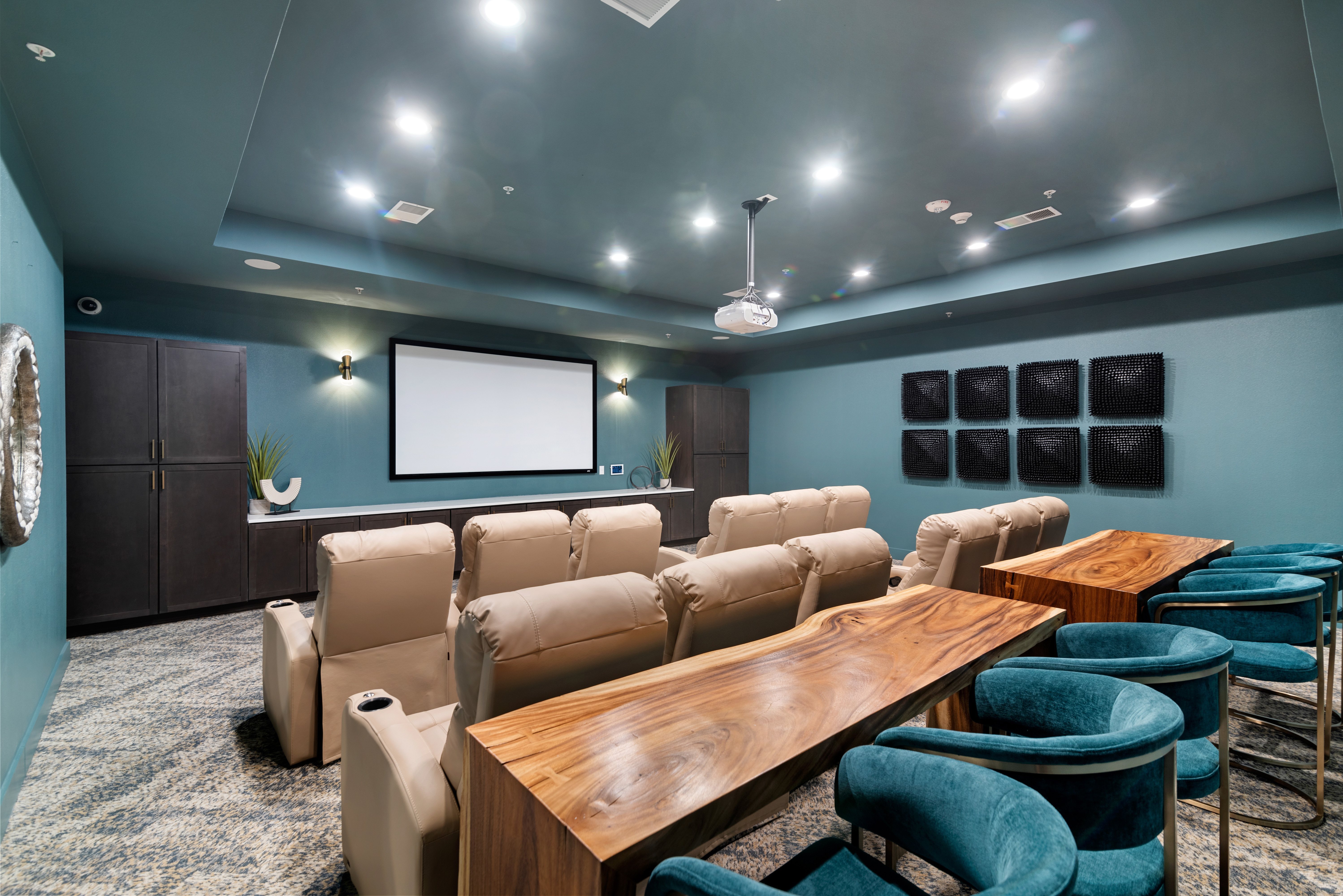 A room with a long table and chairs is set up for a meeting or presentation.