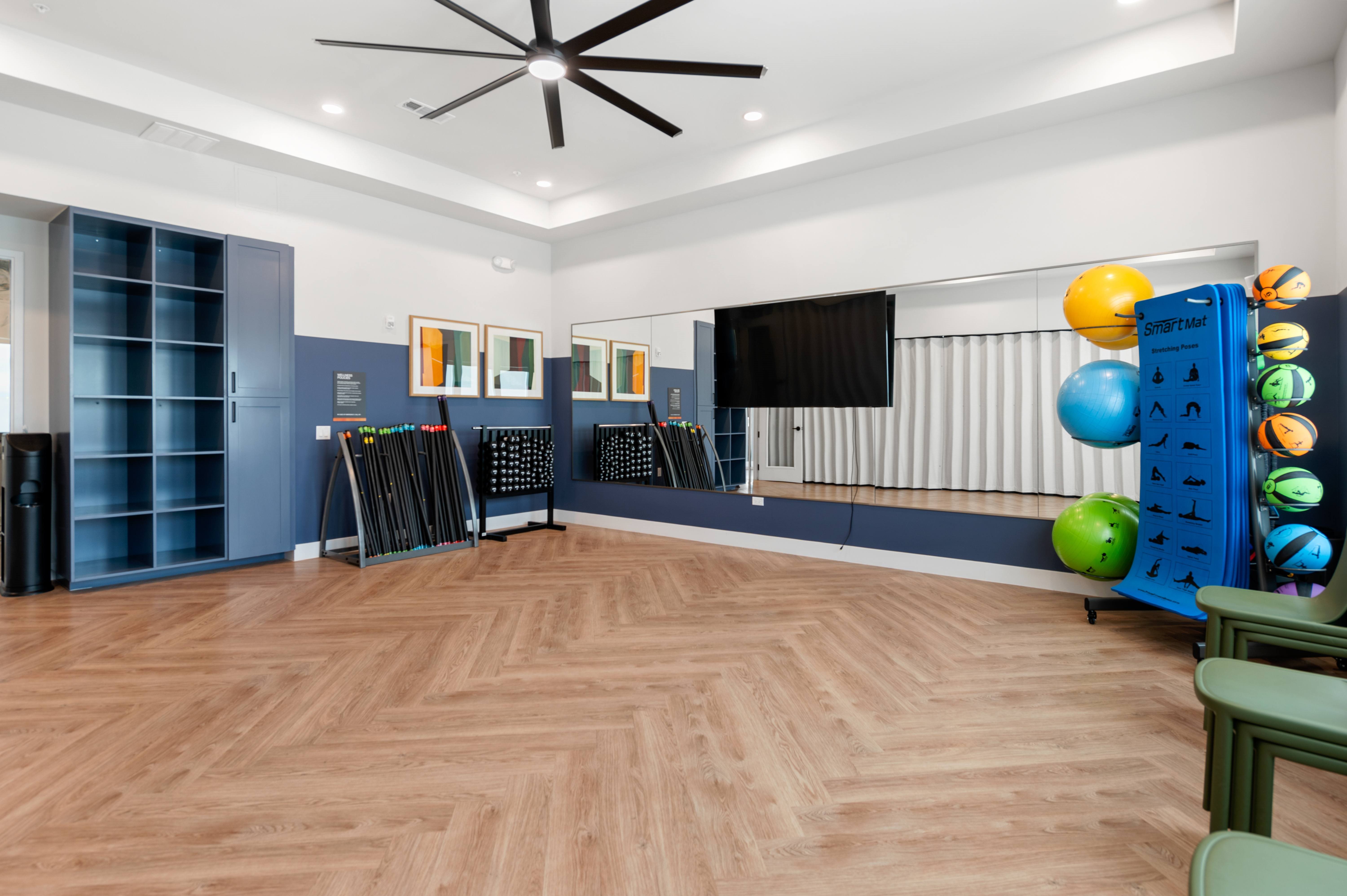 A room with a wooden floor and a ceiling fan.