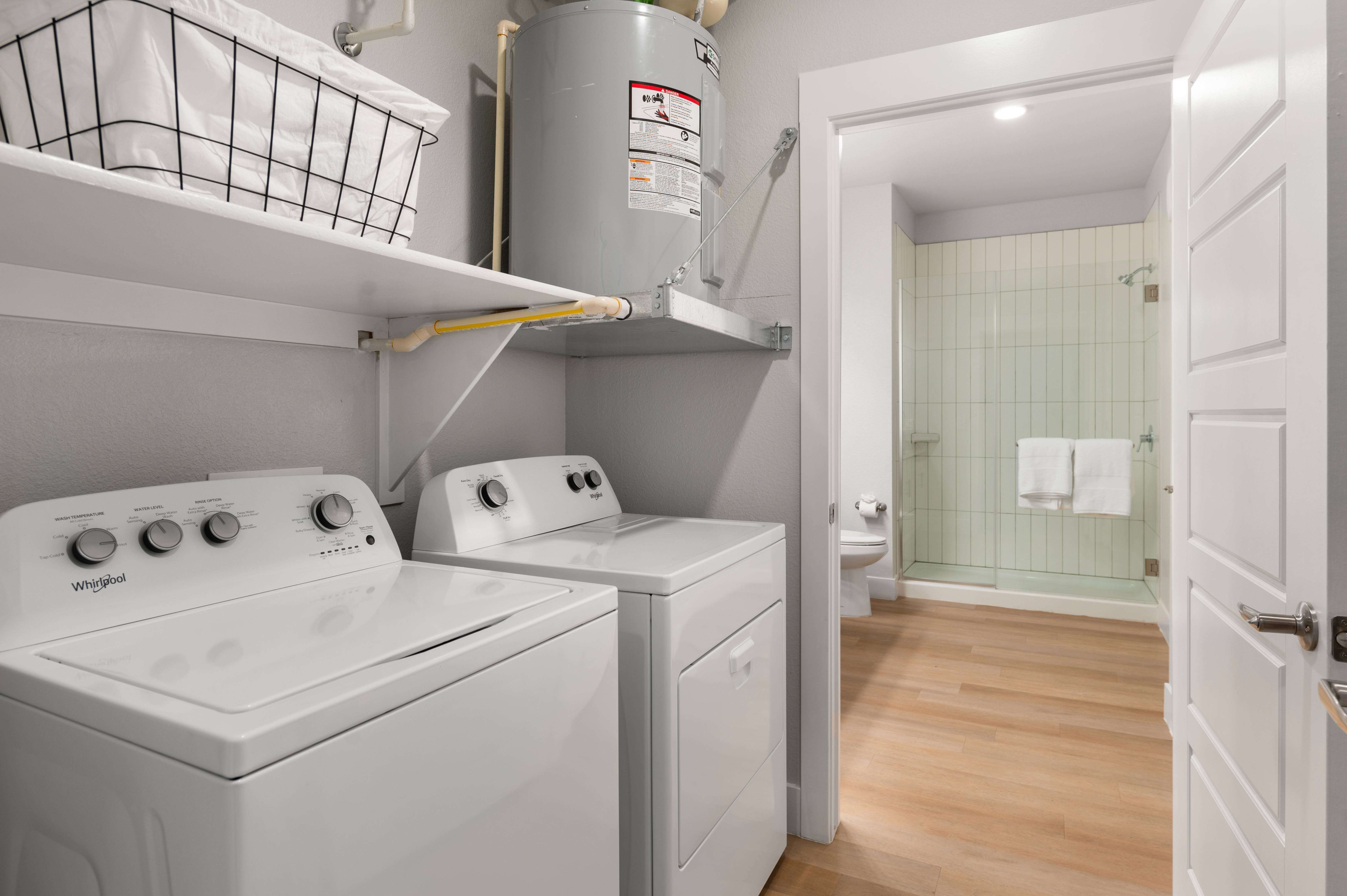 A small laundry room with a washer and dryer.