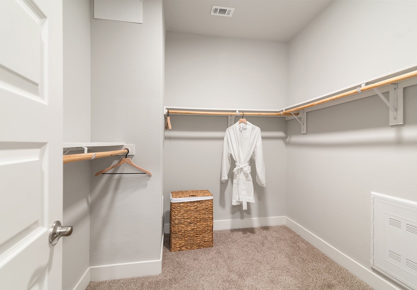 A white bathroom with a towel hanging on a rack.