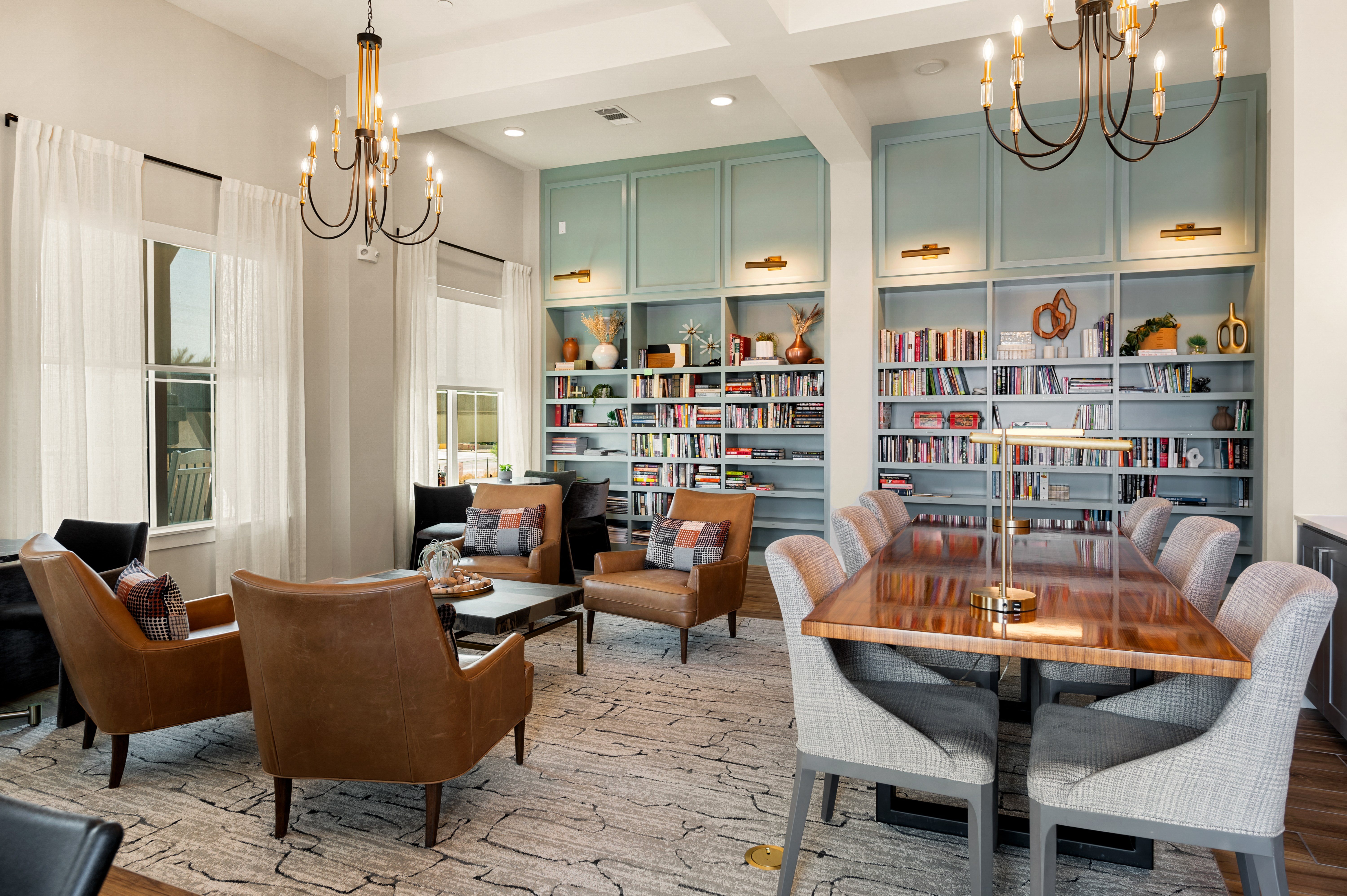 a conference room with a table and chairs and a bookshelf