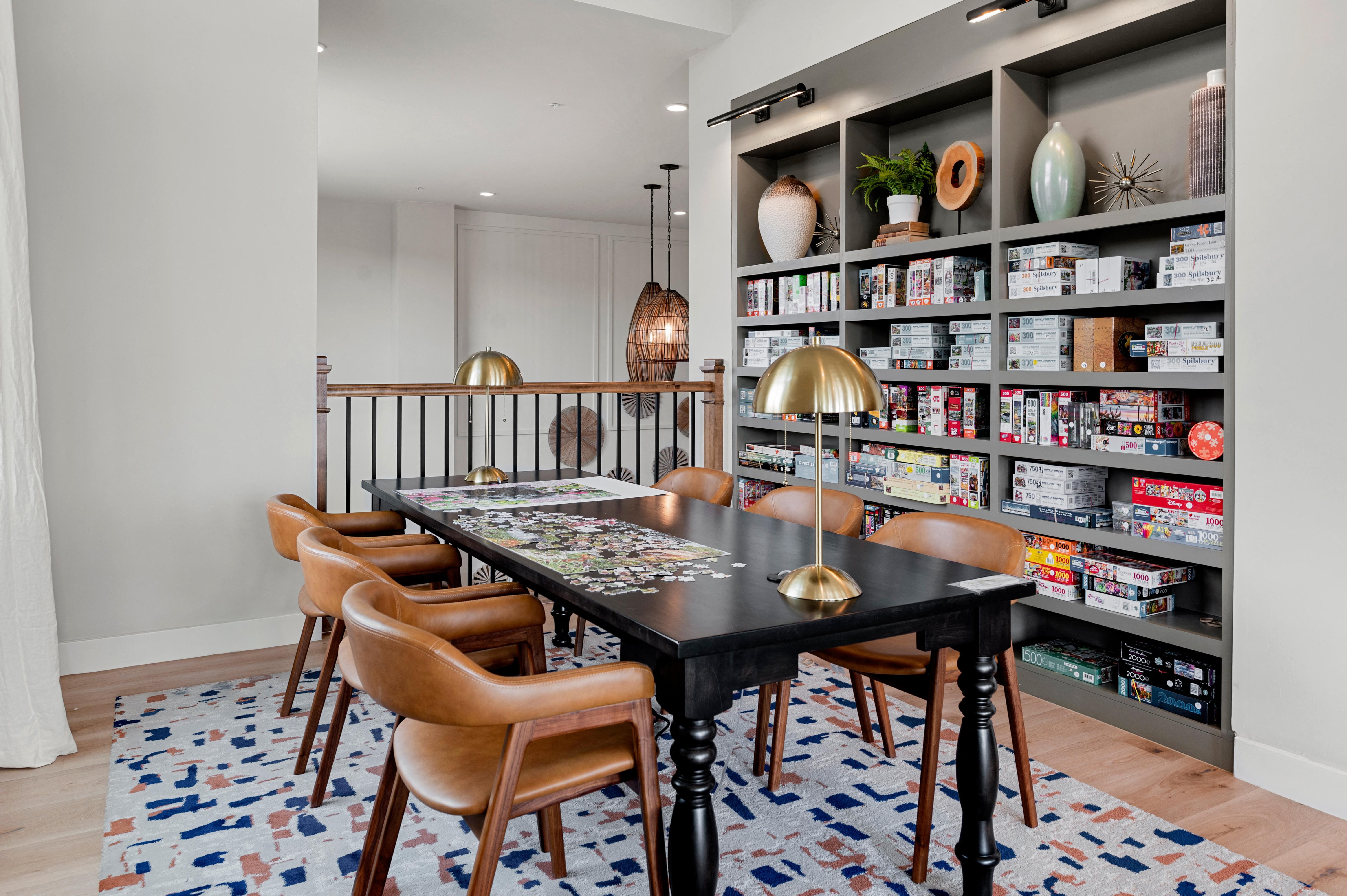 a dining room with a table and chairs and a bookshelf