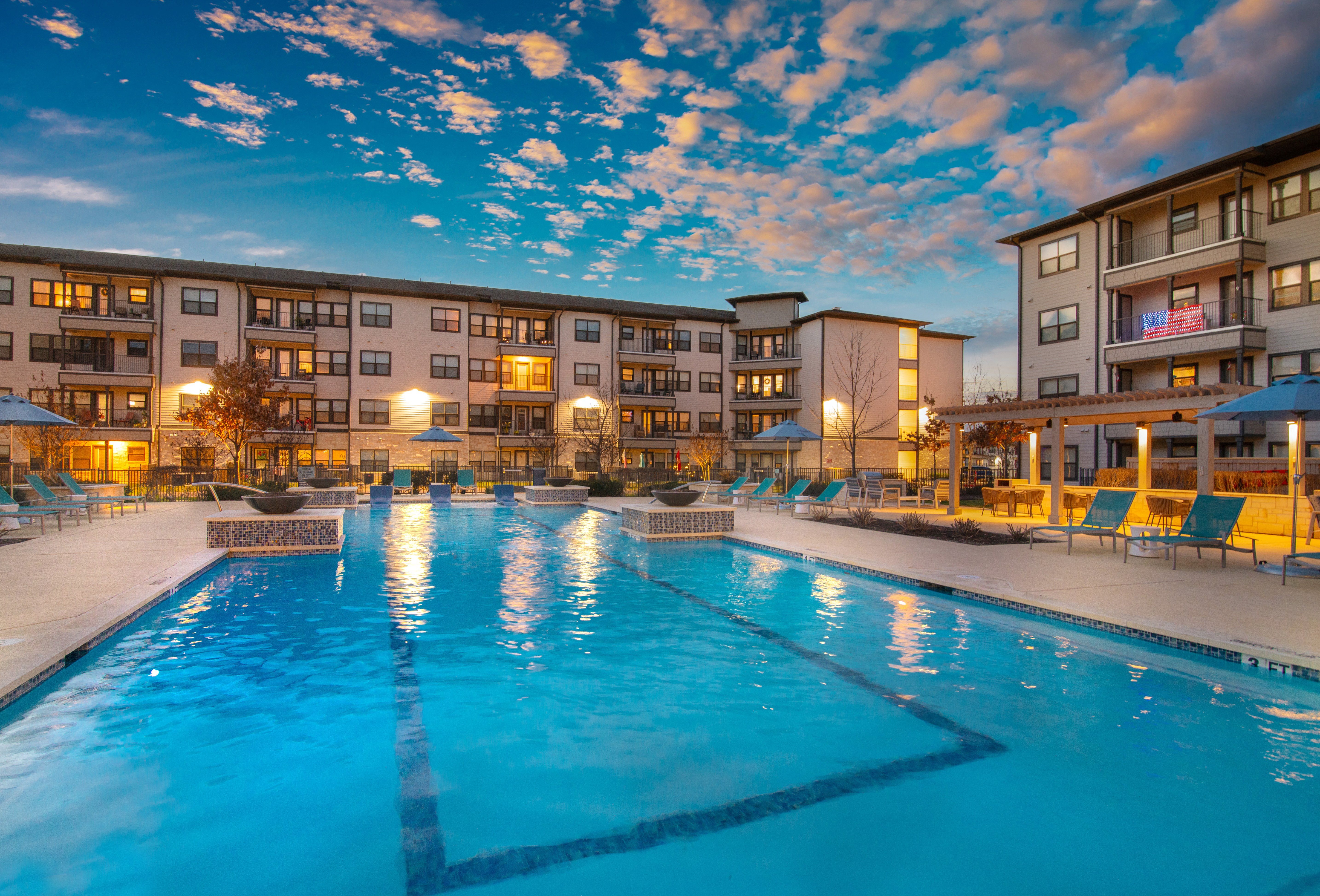 a resort-style pool and patio area at a senior apartment community