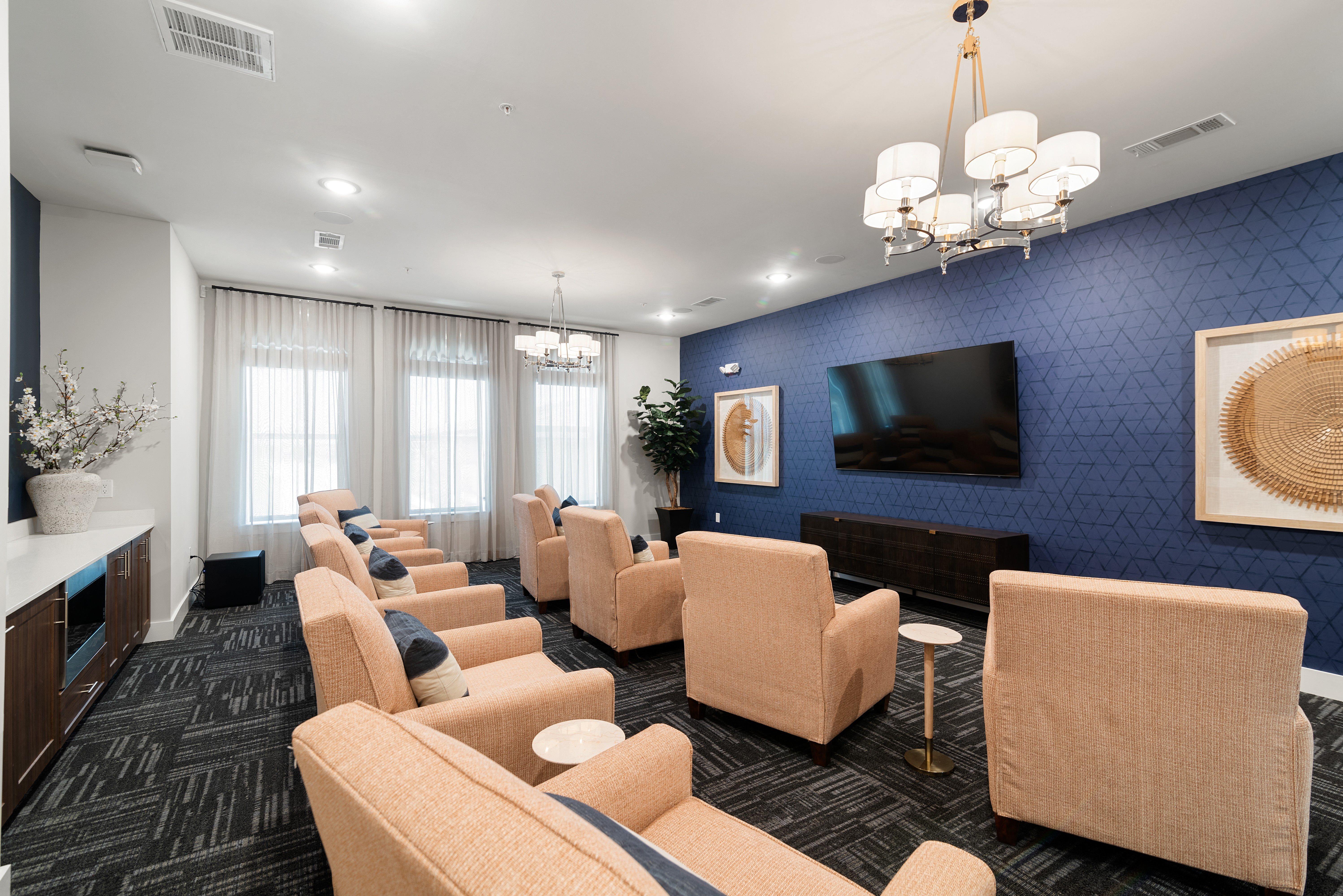 a lounge room with chairs and a television