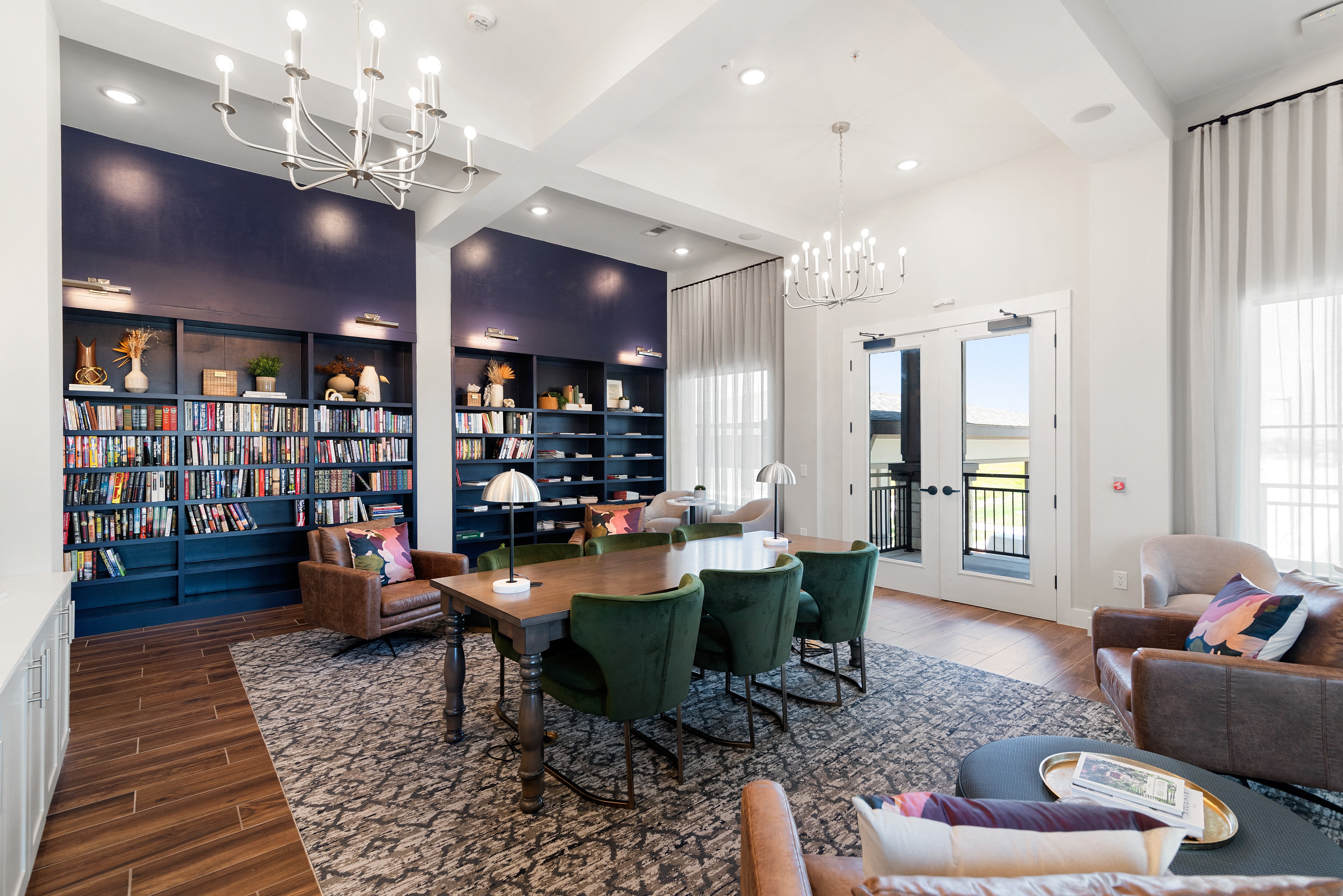 a living room with a table and chairs and a library