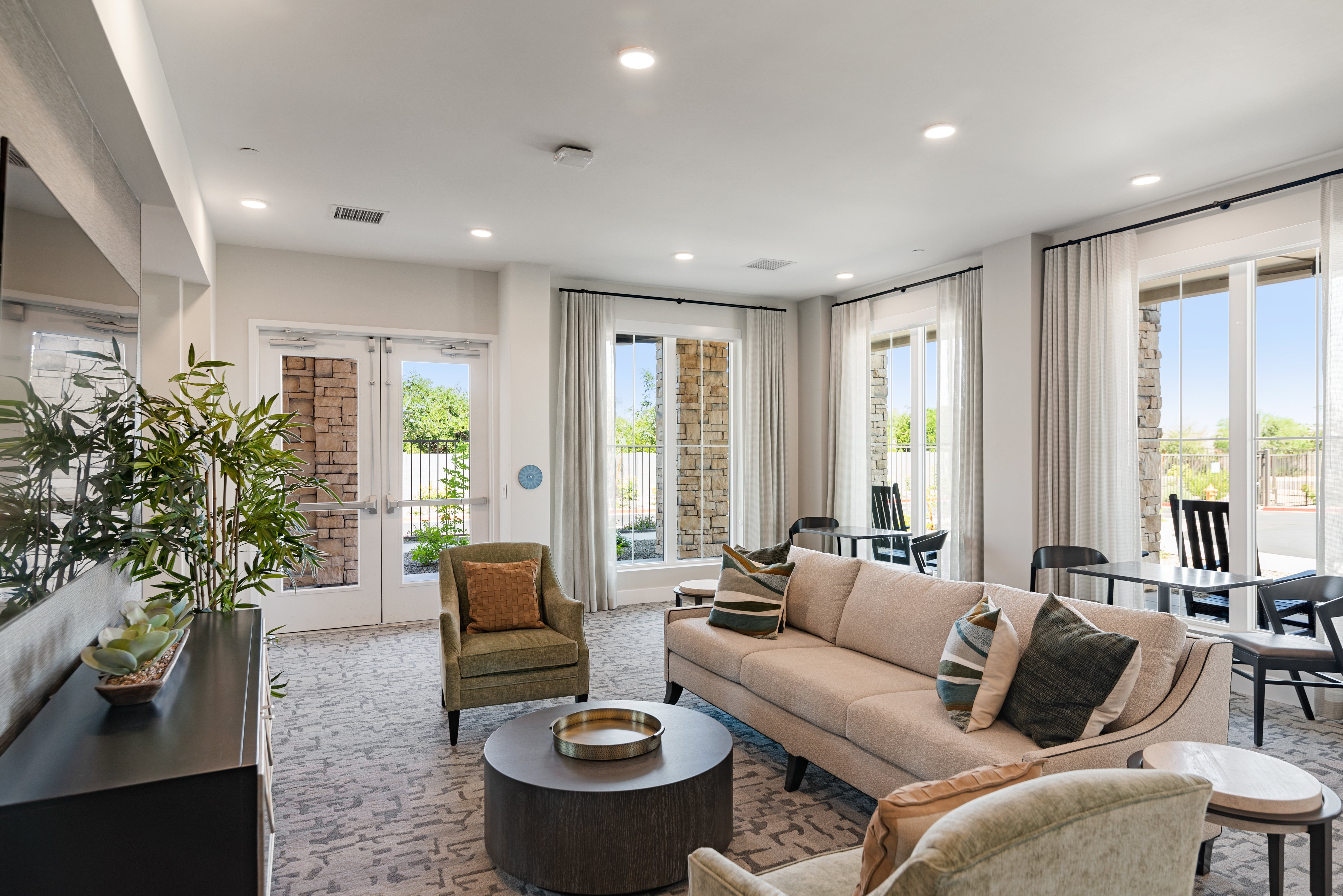A living room with a couch, chairs, and a coffee table.
