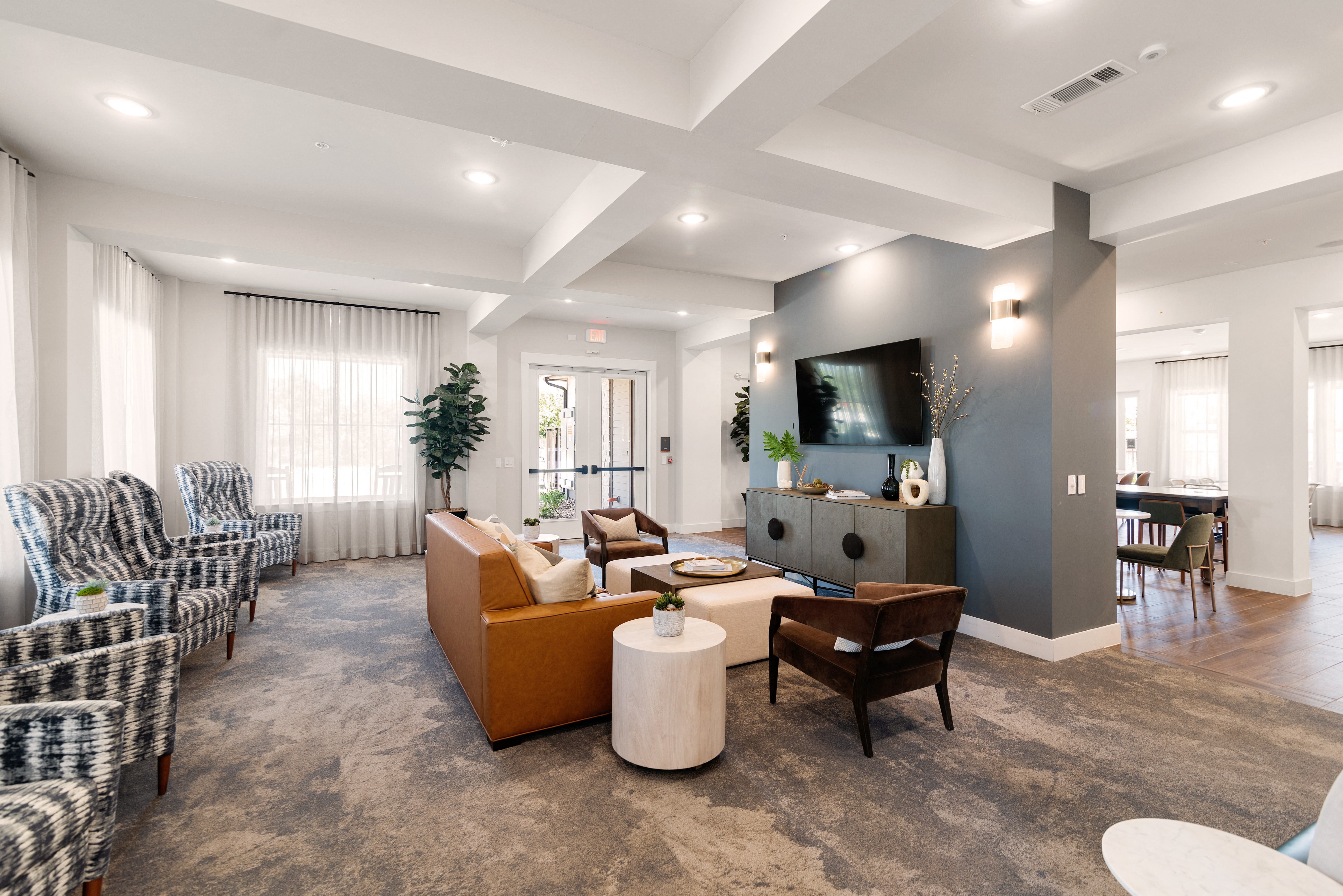 a living room with couches and chairs and a tv
