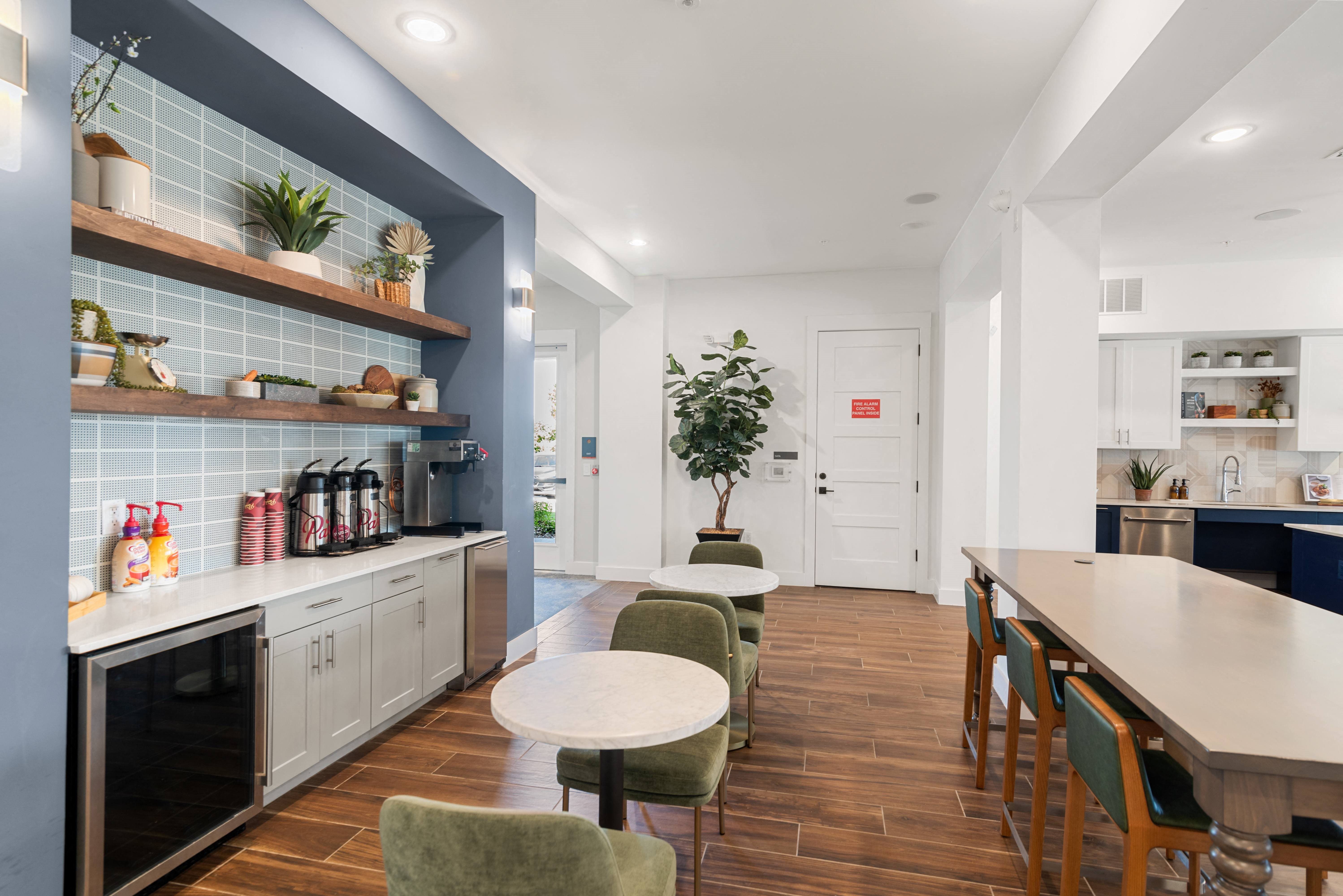 a dining room with a table and chairs and a kitchen